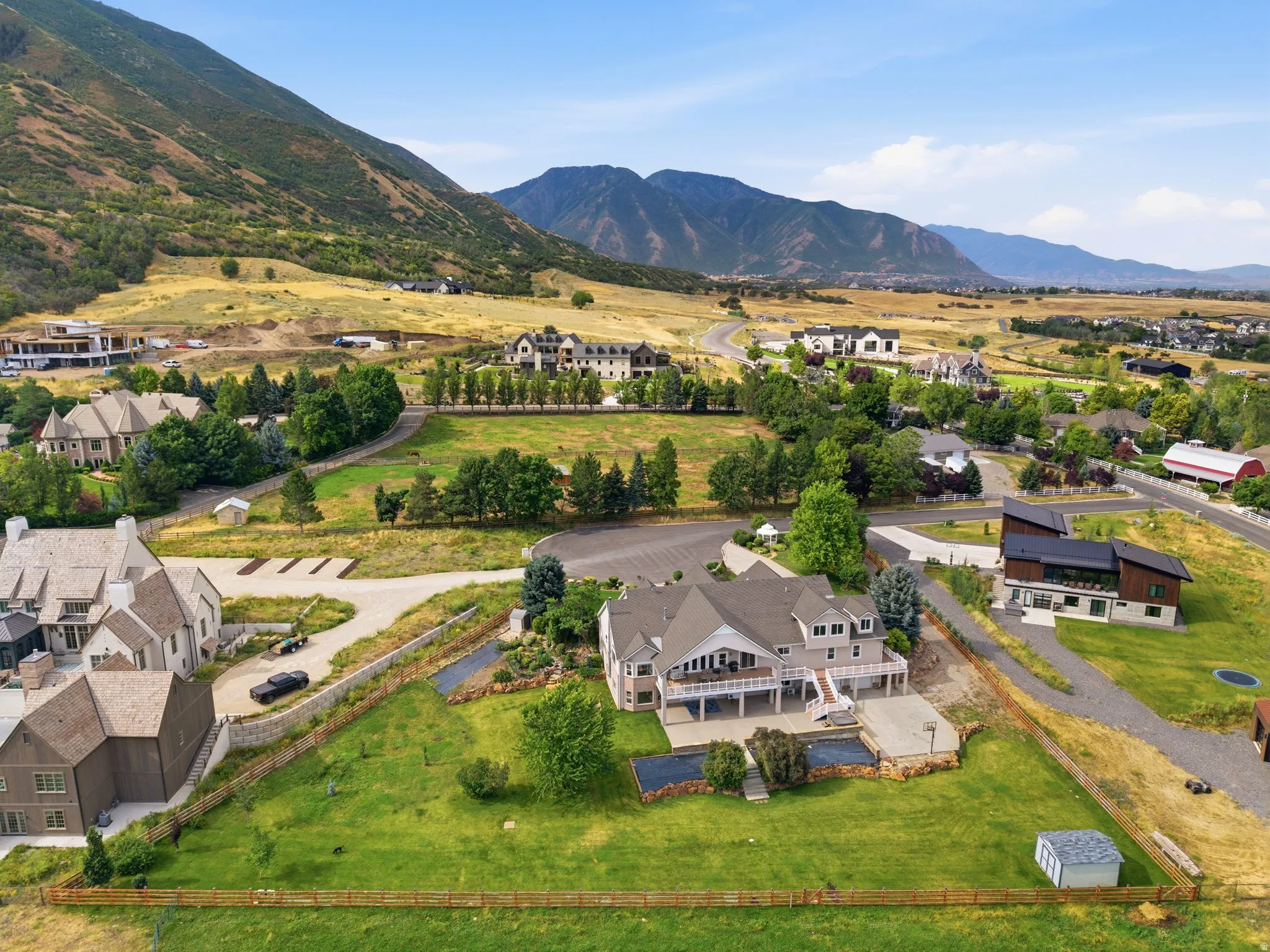 Expansive property featuring a two-story residence with a large deck and multiple outdoor living areas