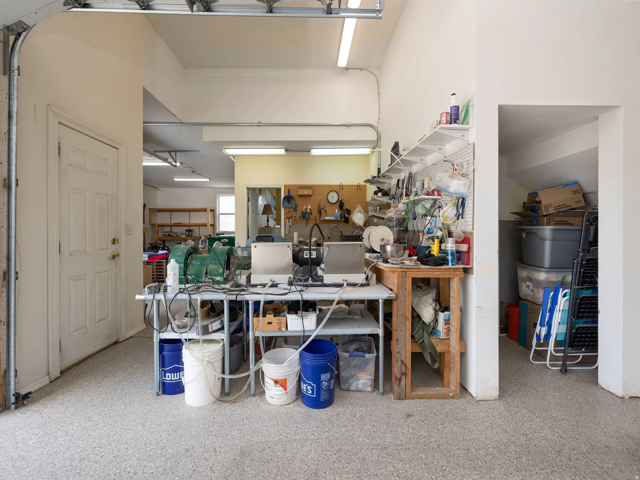 Garage with epoxy flooring and overhead lighting