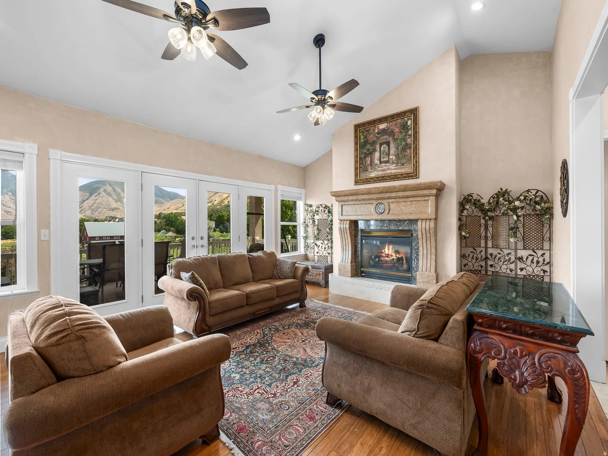 Vaulted ceiling with multiple ceiling fans and recessed lighting