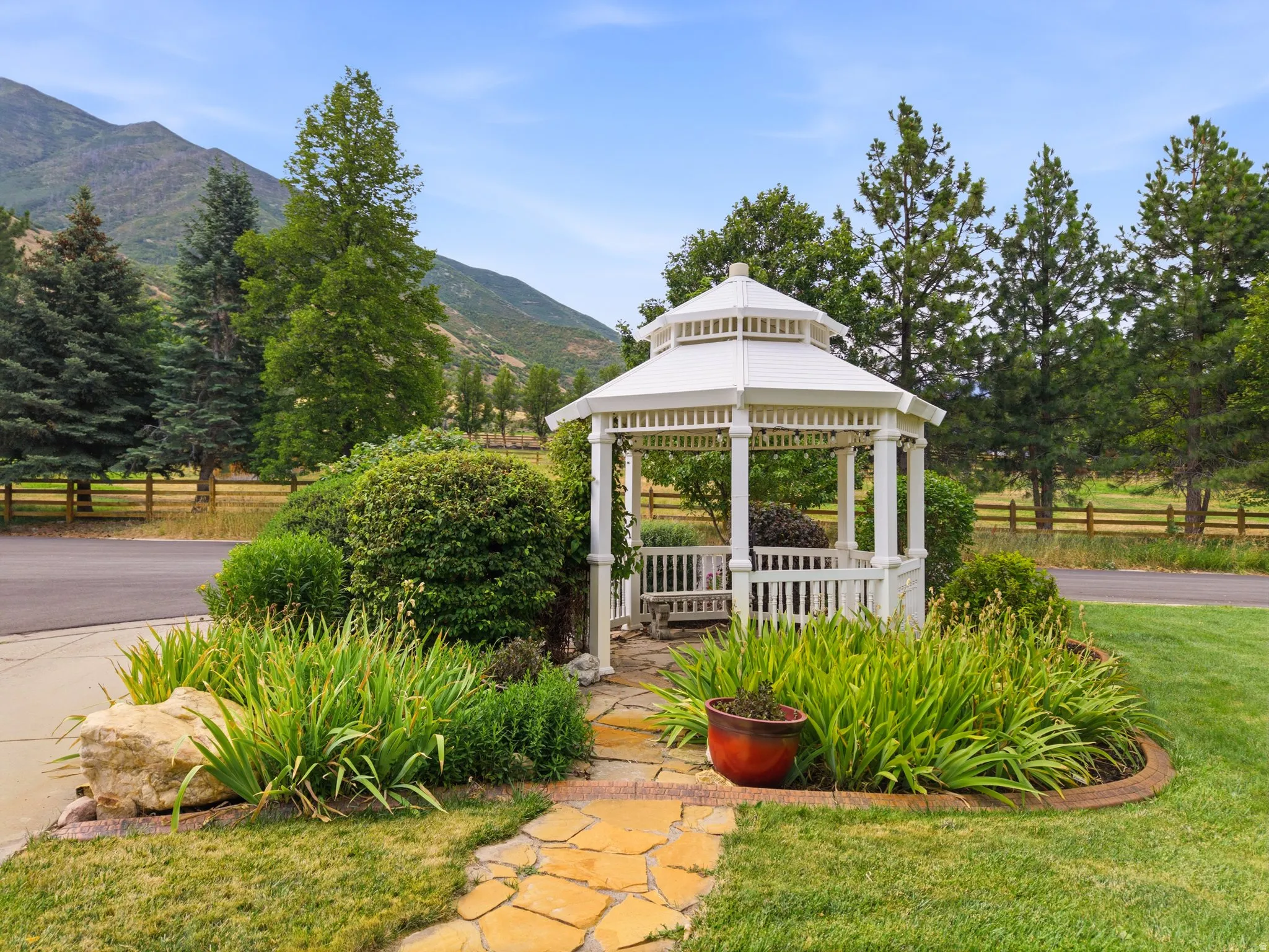 White hexagonal gazebo with built-in bench seating