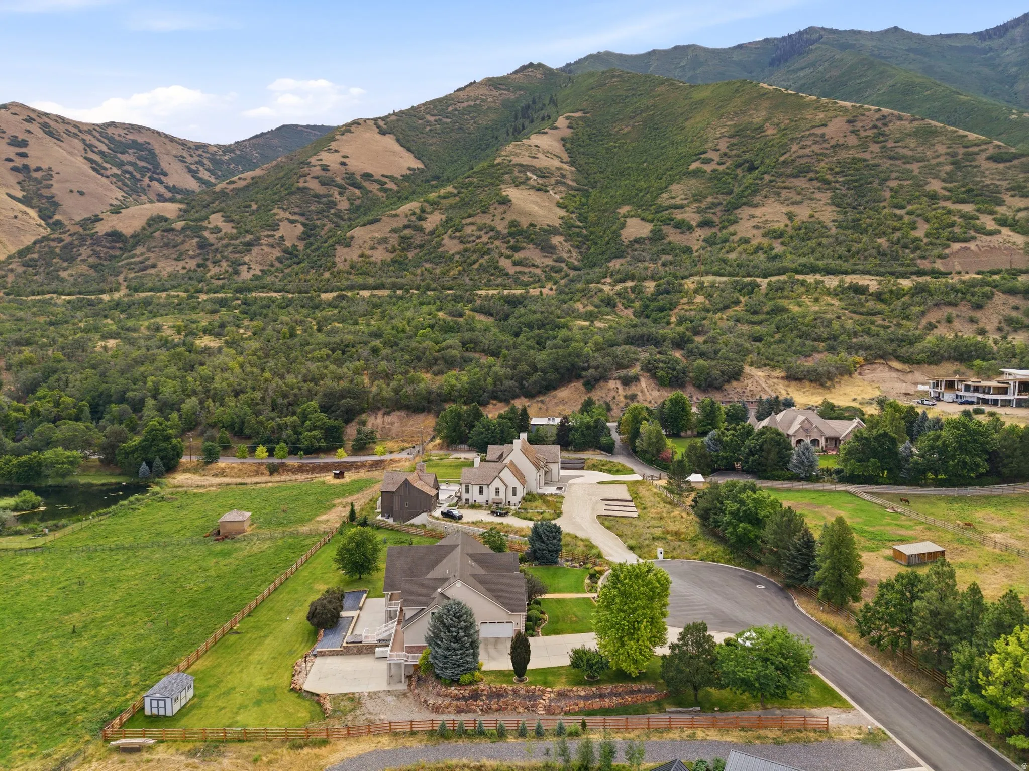 Aerial perspective showcasing multiple properties nestled against a mountain backdrop
