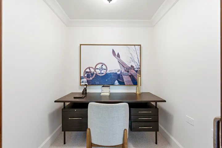 Dedicated office space featuring crown molding, white walls, and light-colored carpeting