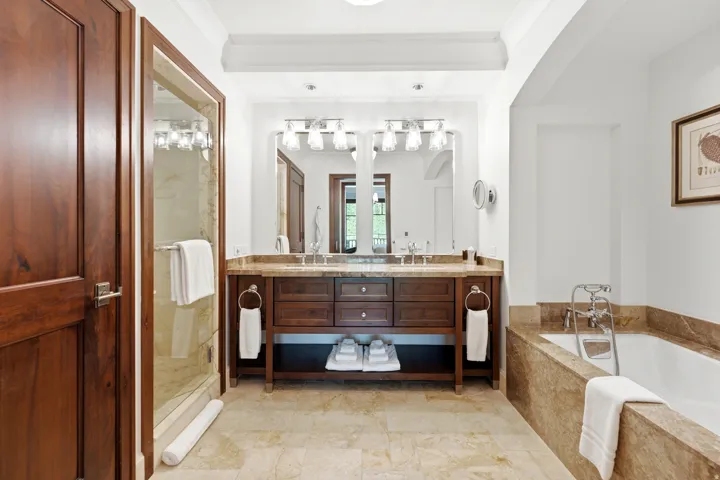 Dual vanity with stone countertop and individual framed mirrors