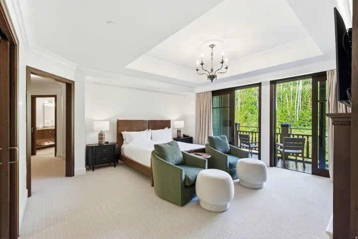 Bedroom featuring private balcony access, tray ceiling with chandelier, recessed lighting, and carpeted flooring