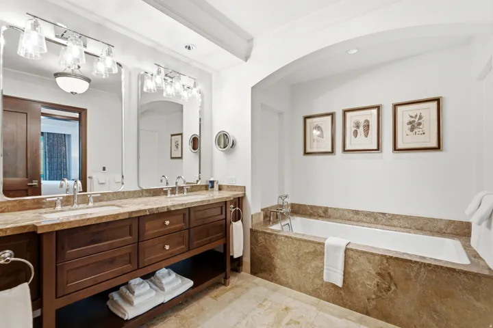 Bathroom featuring a double vanity with stone countertops and undermount sinks