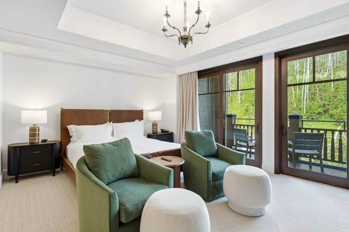Spacious room featuring a tray ceiling, recessed lighting, and a chandelier