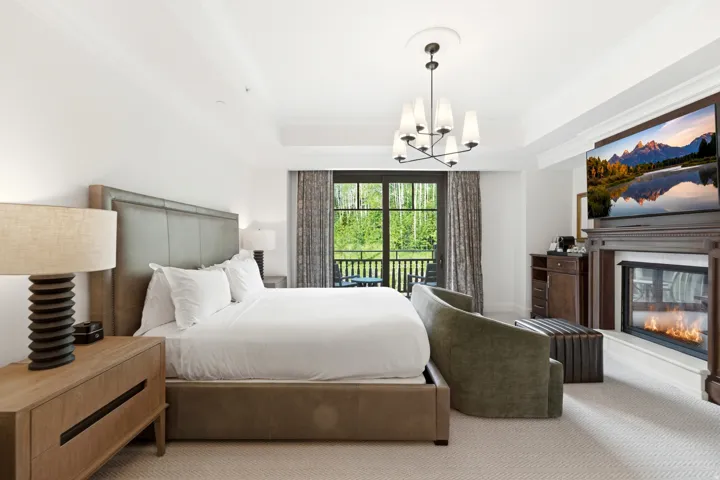 Spacious interior featuring a built-in fireplace with mantel, crown molding, and a chandelier