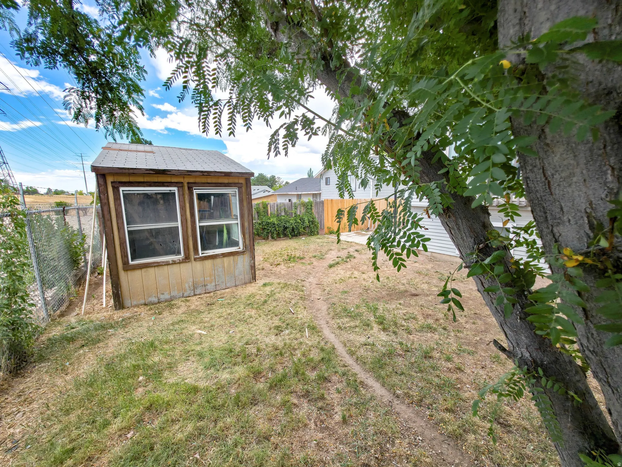 Backyard: Shed, RV/patio on right.