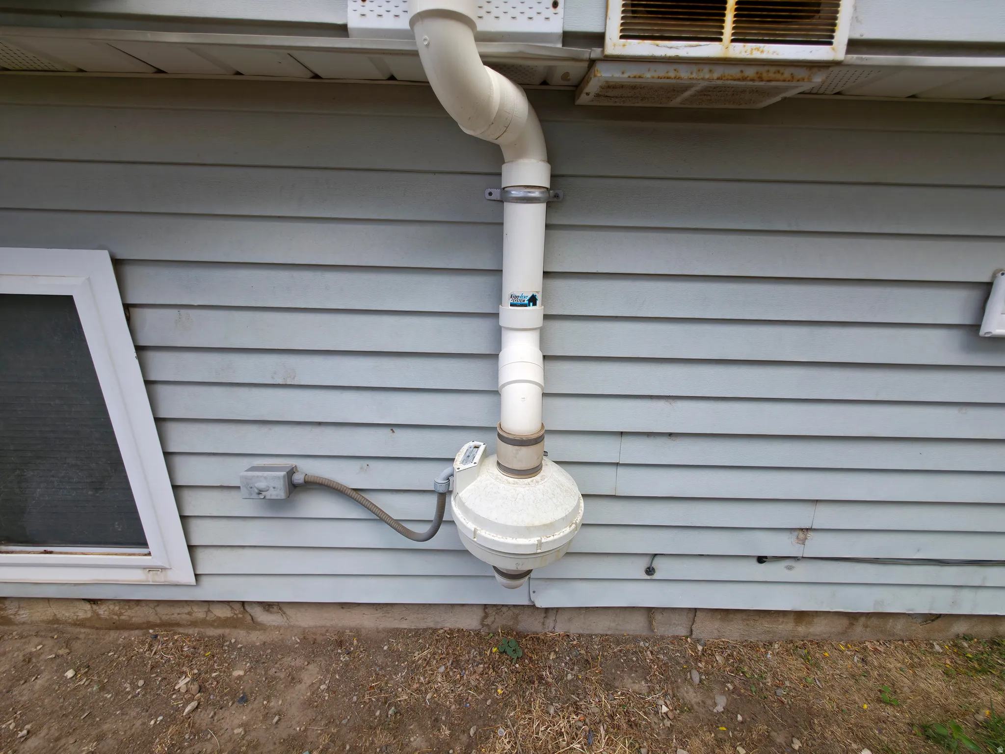 Back yard: low voltage radon system fan and vent.