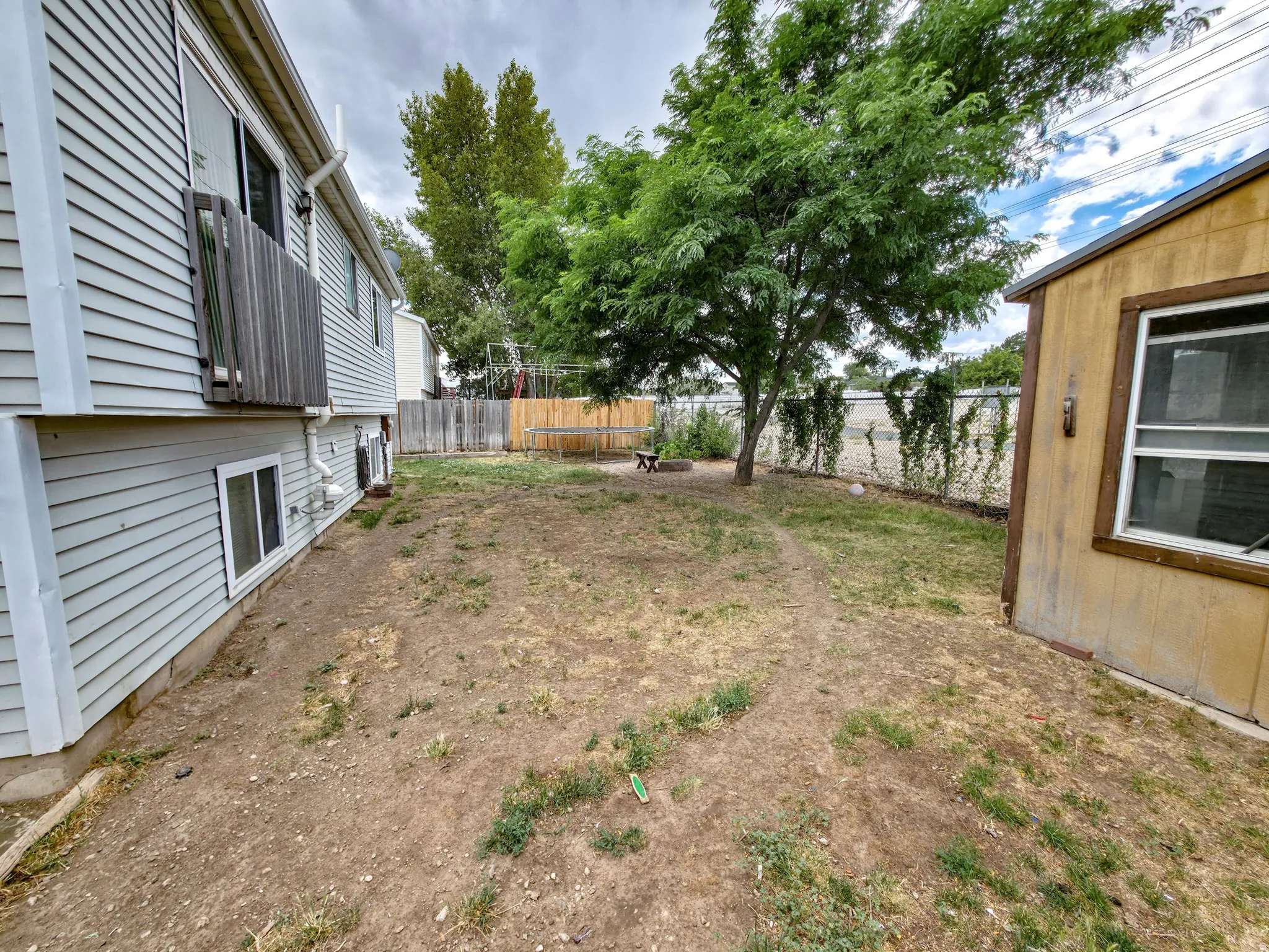 Backyard: House left, firepit center, shed right.