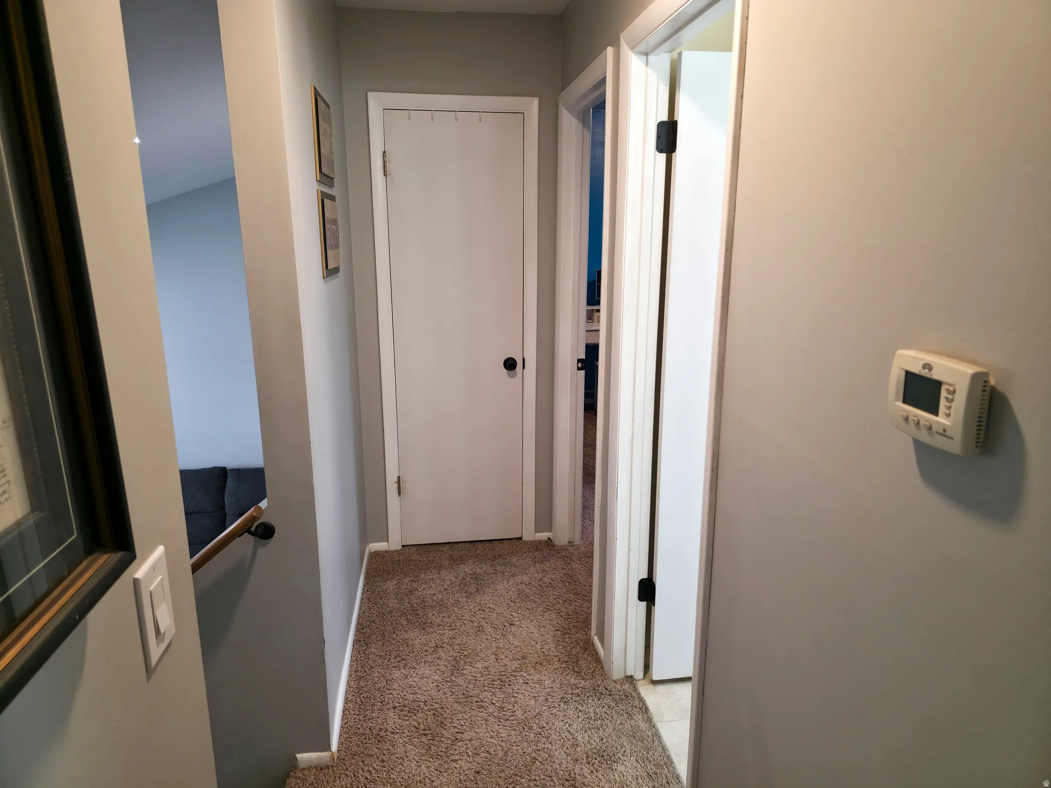 stairs down at left. linen closet at center. Bedroom 2, then bathroom on right.
