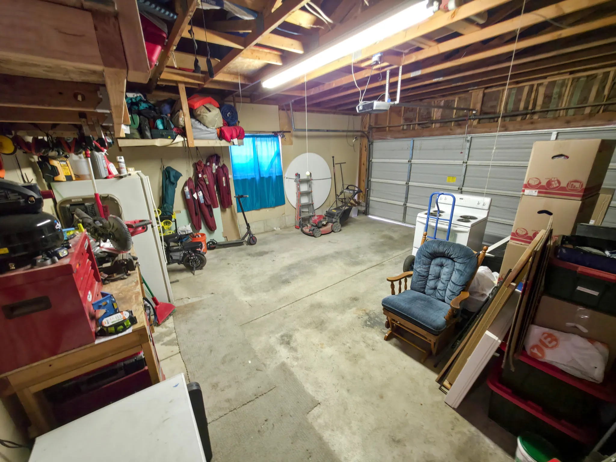 Attached garage: built in shelving and  workbench.