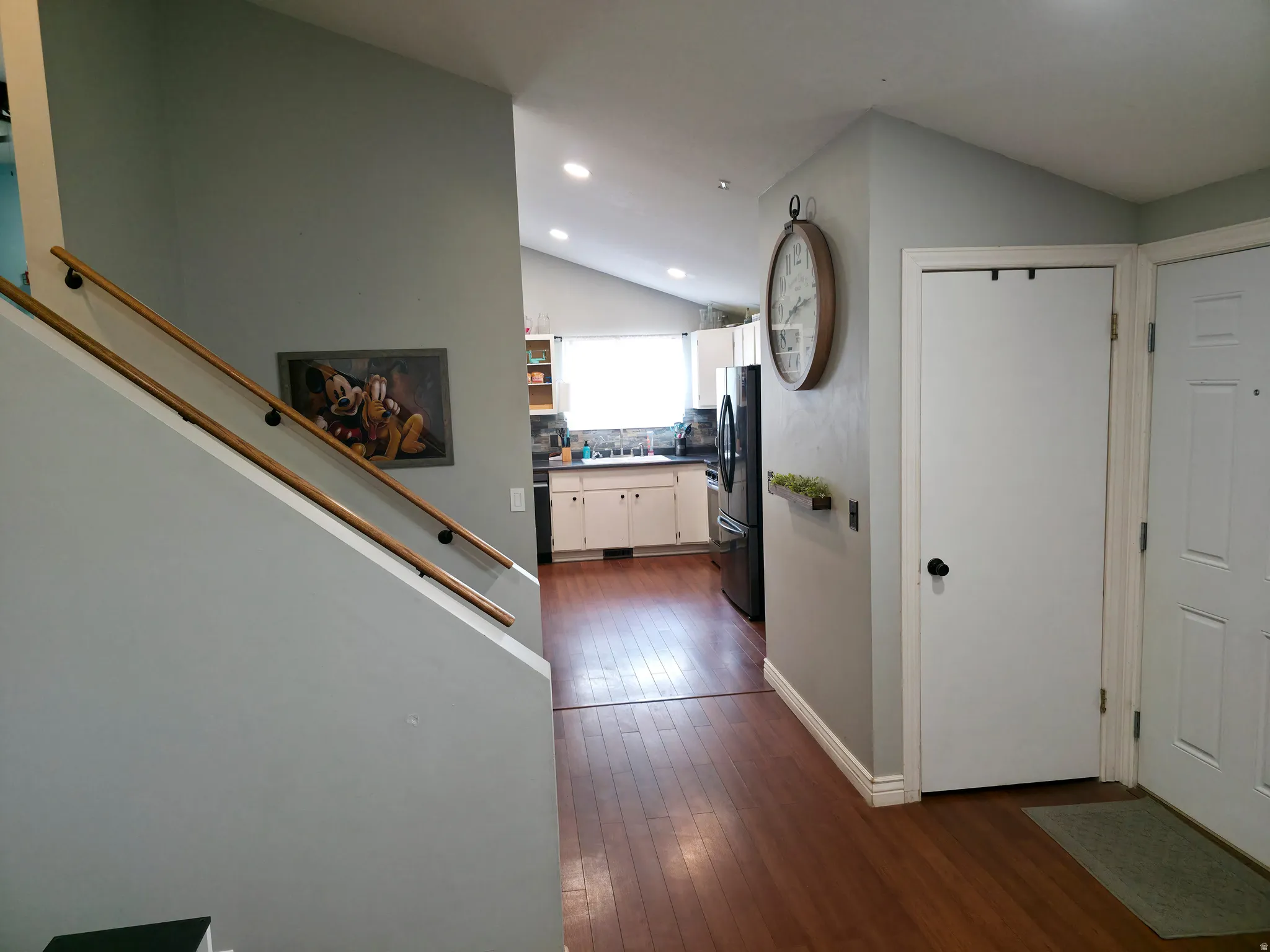 Stairs up, then down on right. Kitchen center. Front door on right.