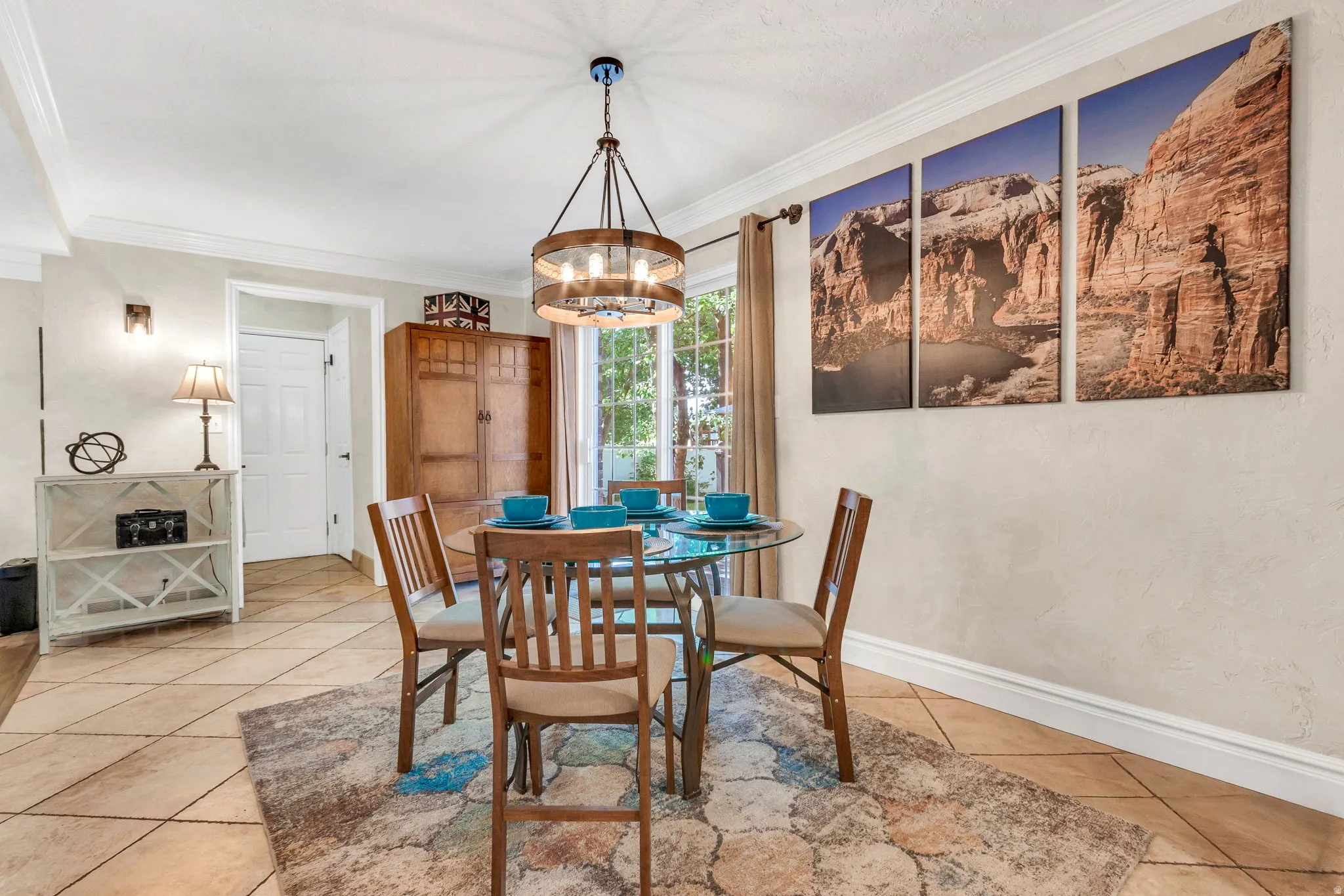 Dining area featuring a wood and metal chandelier, a glass-top table, and diagonal tile flooring