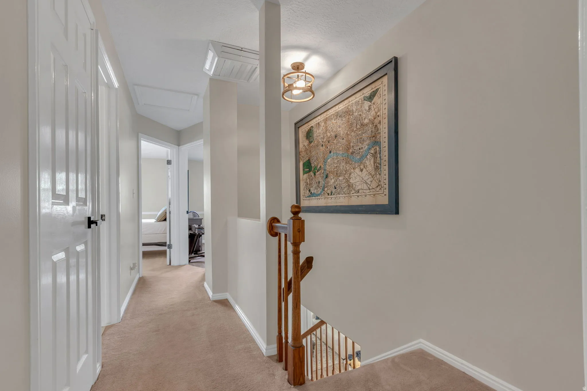 Upstairs hallway with painted walls, white trim, and white paneled doors