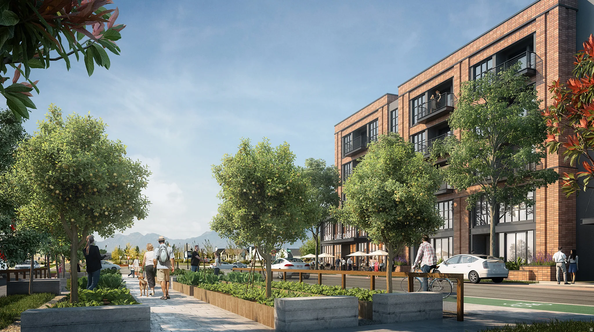 Brick facade building featuring multiple balconies, large windows, and ground-level retail spaces with outdoor seating