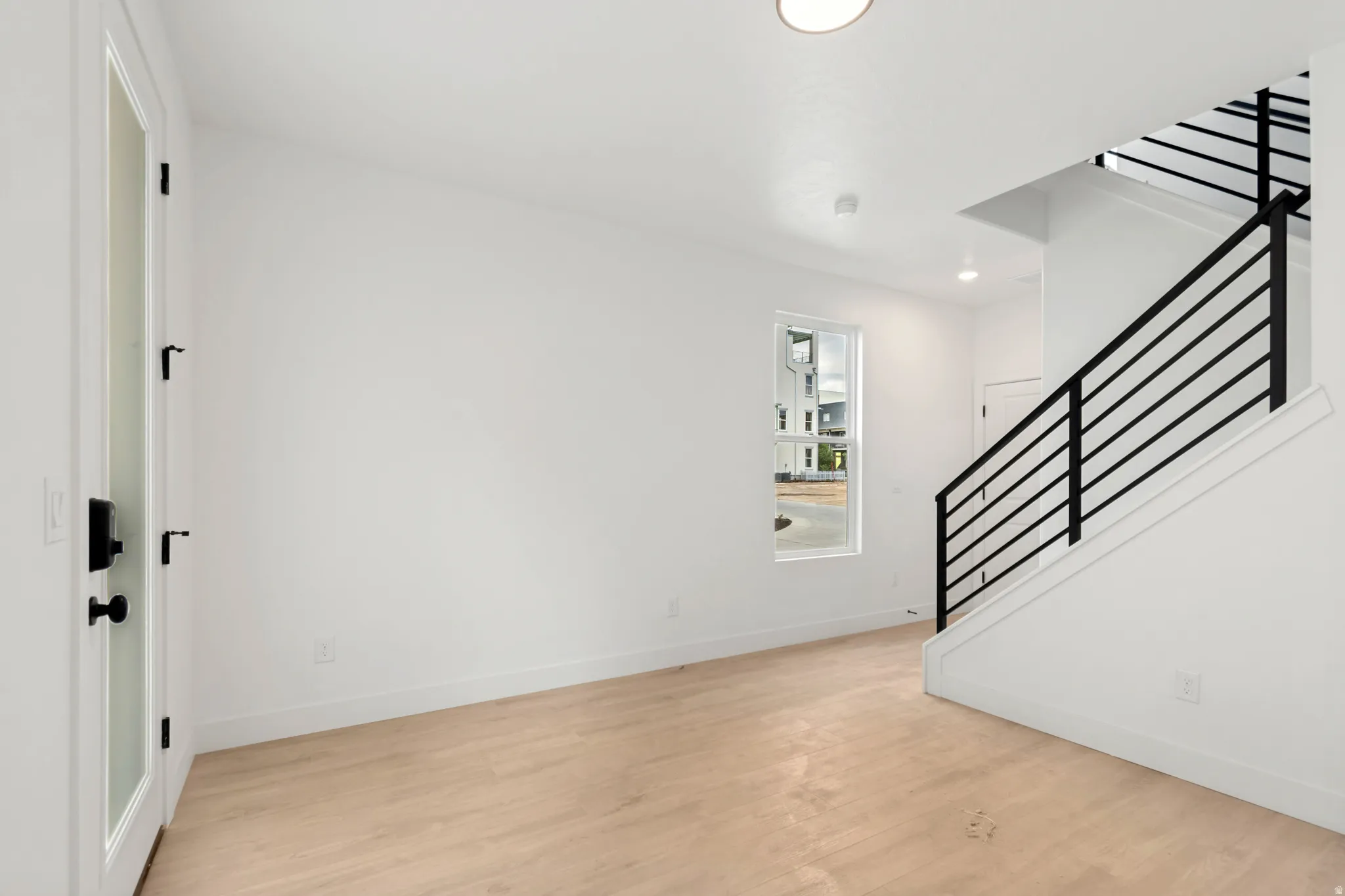 Light wood-finish flooring with white walls