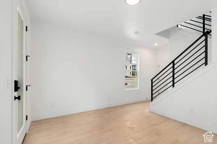 Light wood-finish flooring with white walls