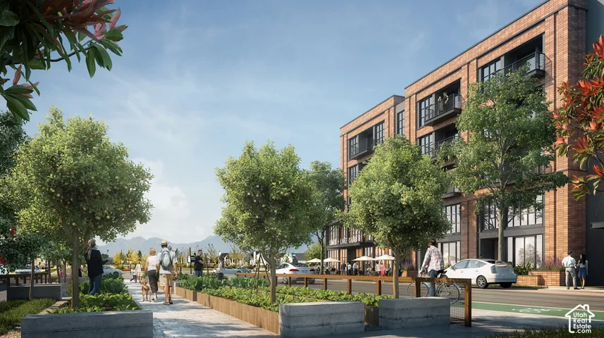 Brick facade building featuring multiple balconies, large windows, and ground-level retail spaces with outdoor seating