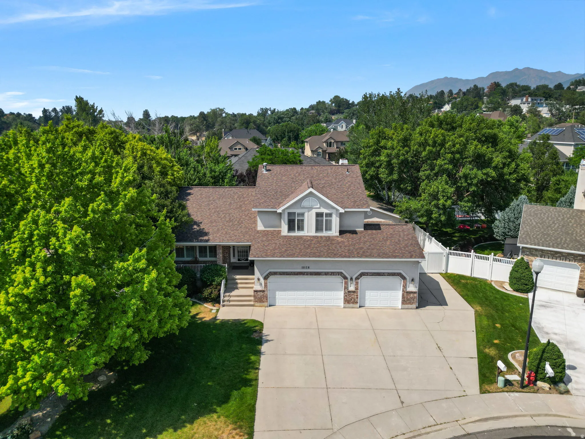 Two-story residence with a multi-gabled roofline and a two-car garage