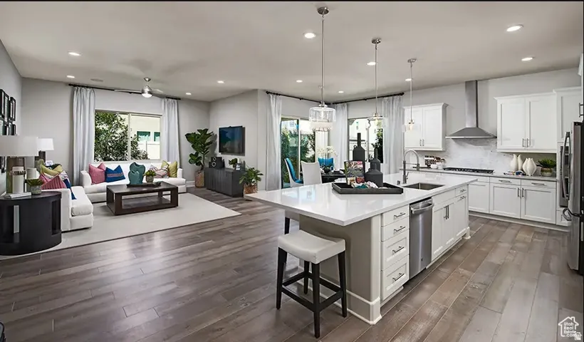 Open-concept living space featuring wood-finish flooring, recessed lighting, and a contemporary ceiling fan