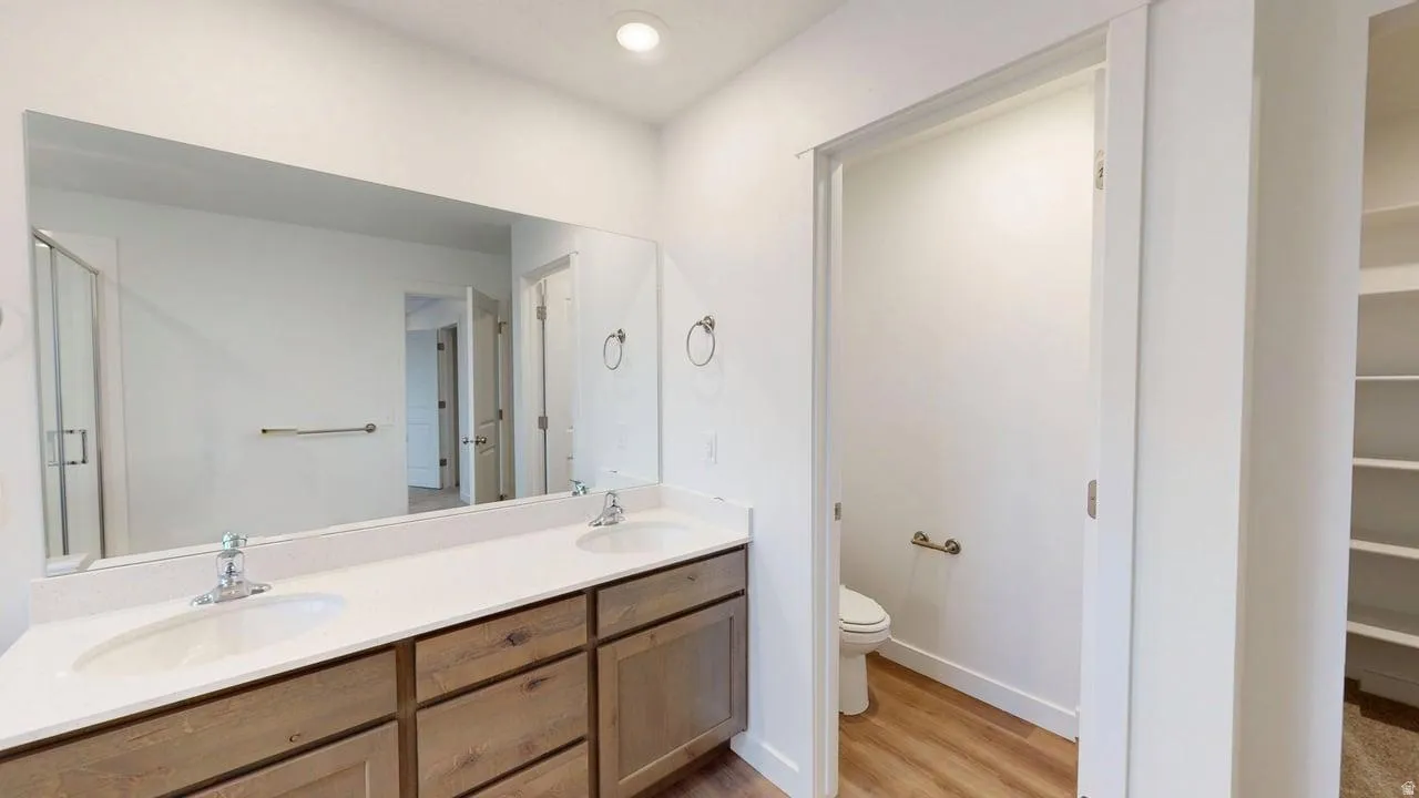 Dual vanity with white undermount sinks, chrome fixtures, and a light-toned countertop