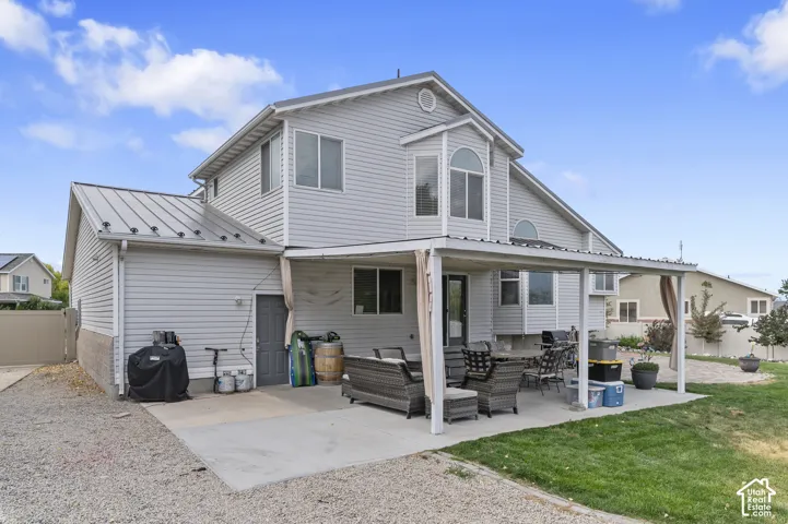 Covered concrete patio extending from the rear of the property