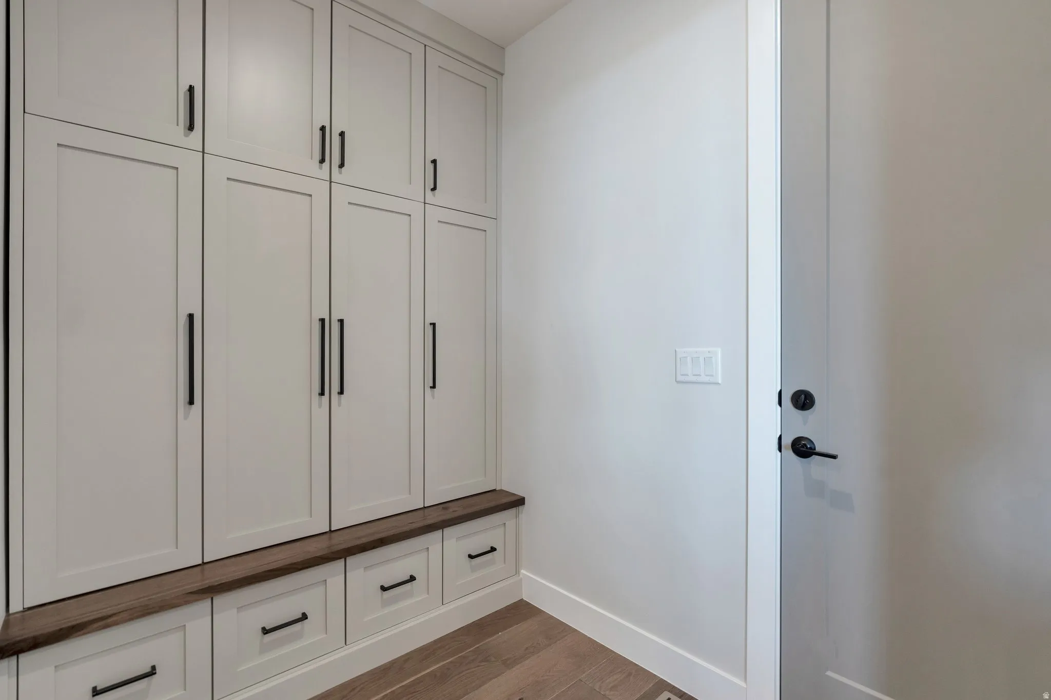 Built-in cabinetry with light-toned shaker style doors and matte black hardware