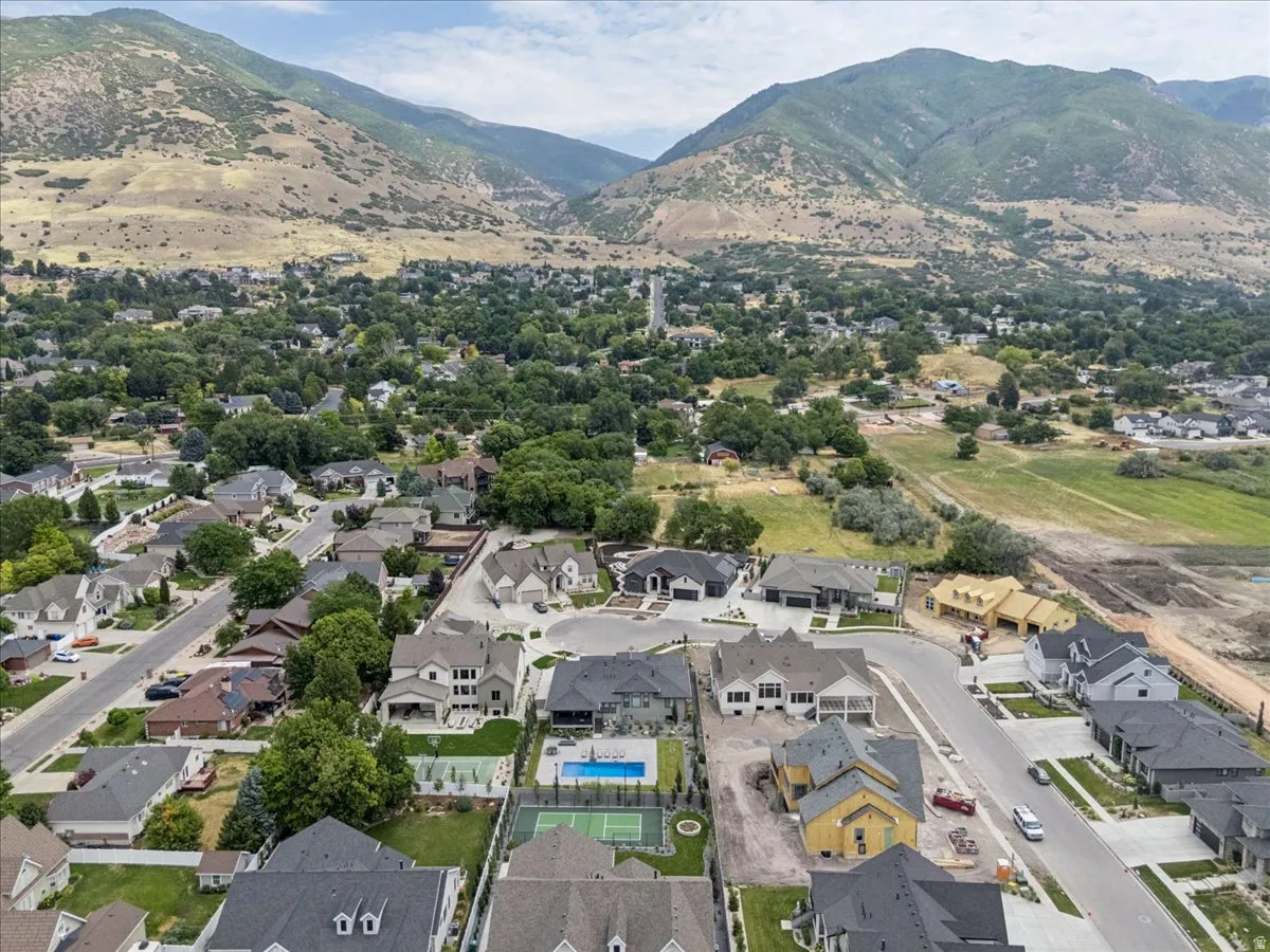 Expansive aerial perspective showcasing a residential neighborhood with mountain backdrop