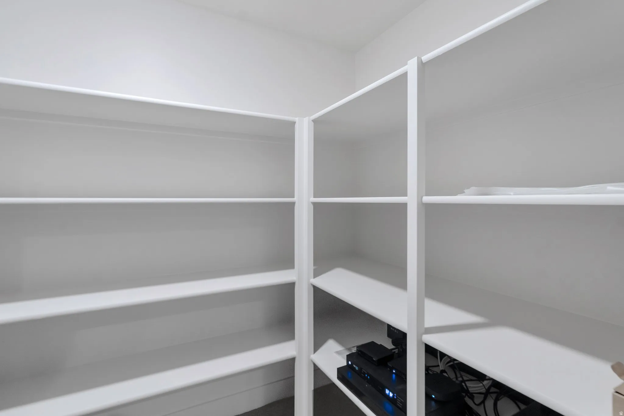 White built-in shelving providing extensive storage capacity