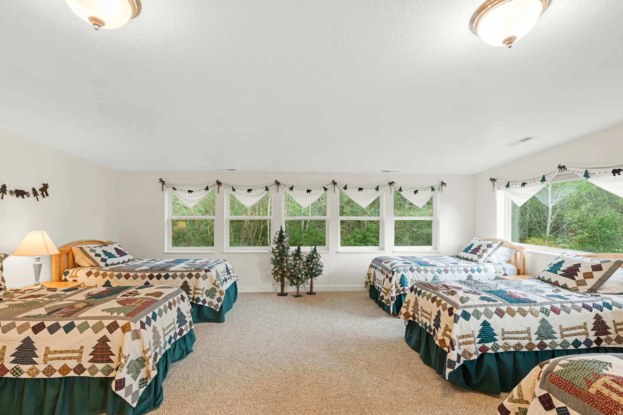 Spacious room with light neutral walls and light beige carpet flooring