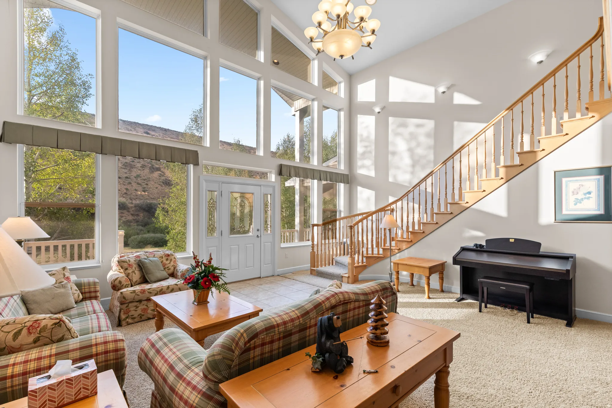 Two-story living area featuring a vaulted ceiling and extensive fenestration