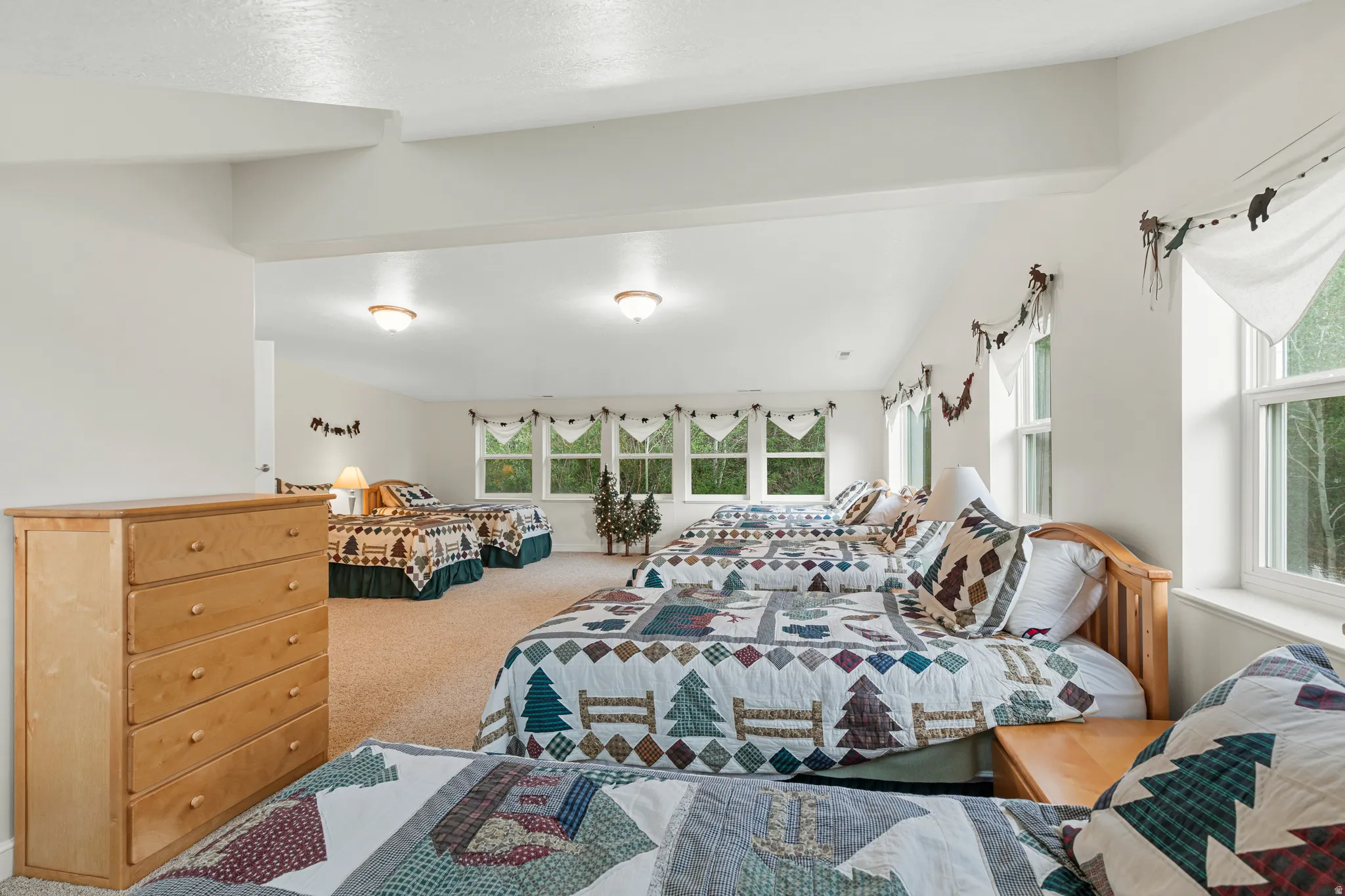 Expansive room featuring light-toned carpeting and multiple windows
