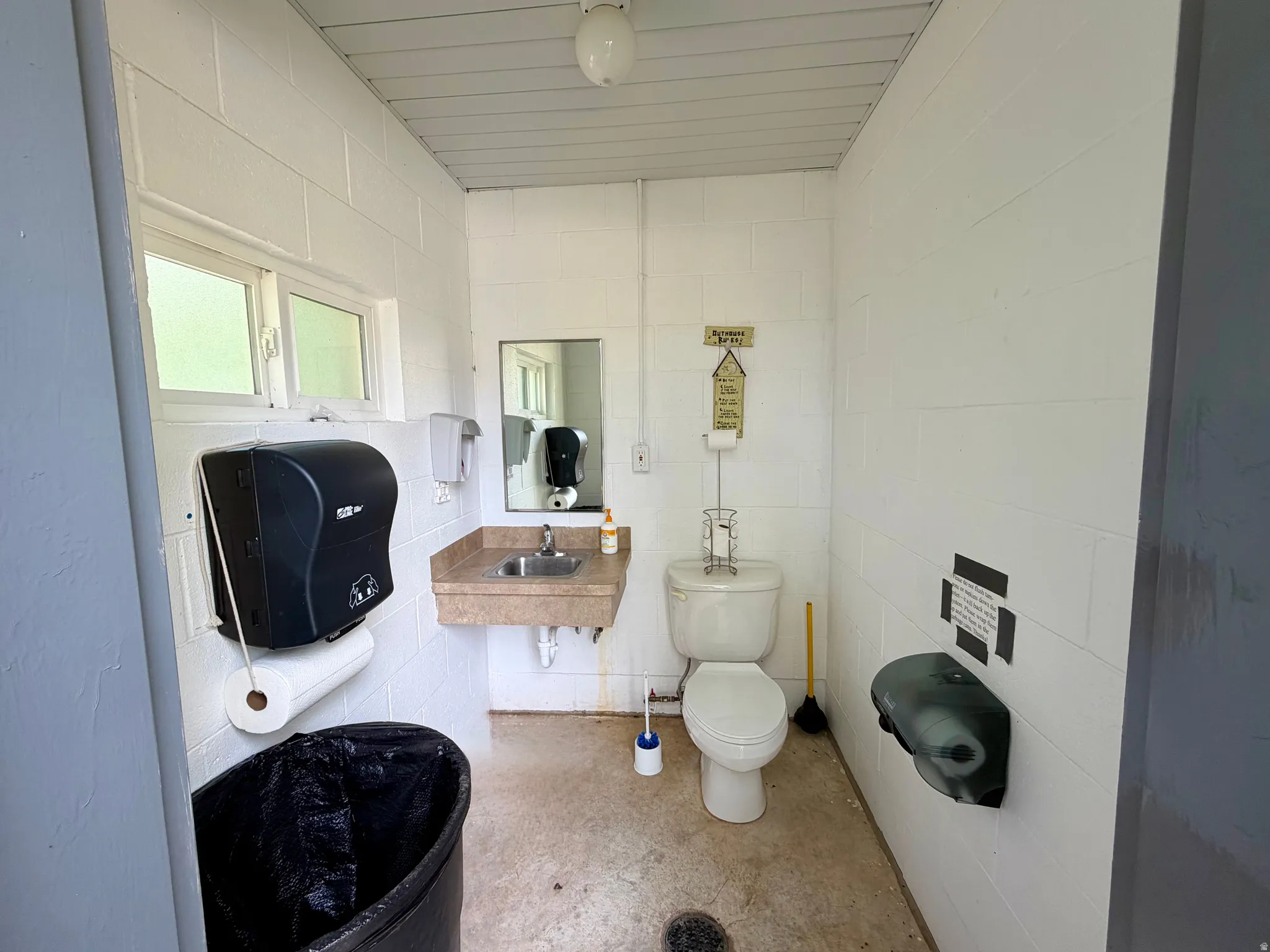 White block wall construction with a built-in vanity sink and mirror
