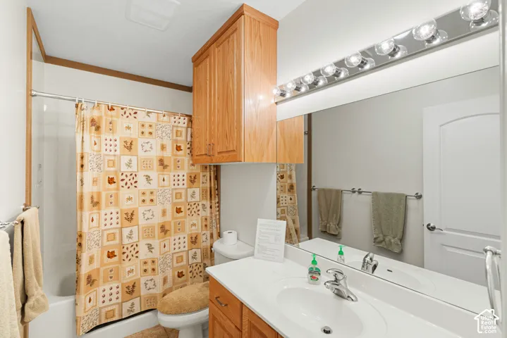 Bathroom featuring a single vanity with a white countertop, chrome faucet, and integrated sink