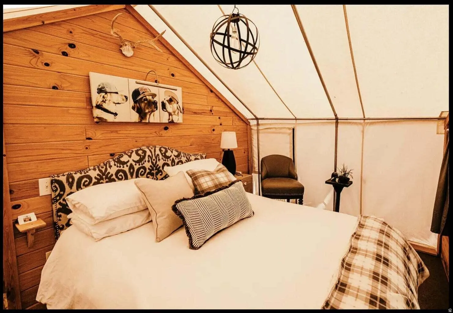 Interior space featuring wood paneling, an upholstered headboard, and a fabric wall system