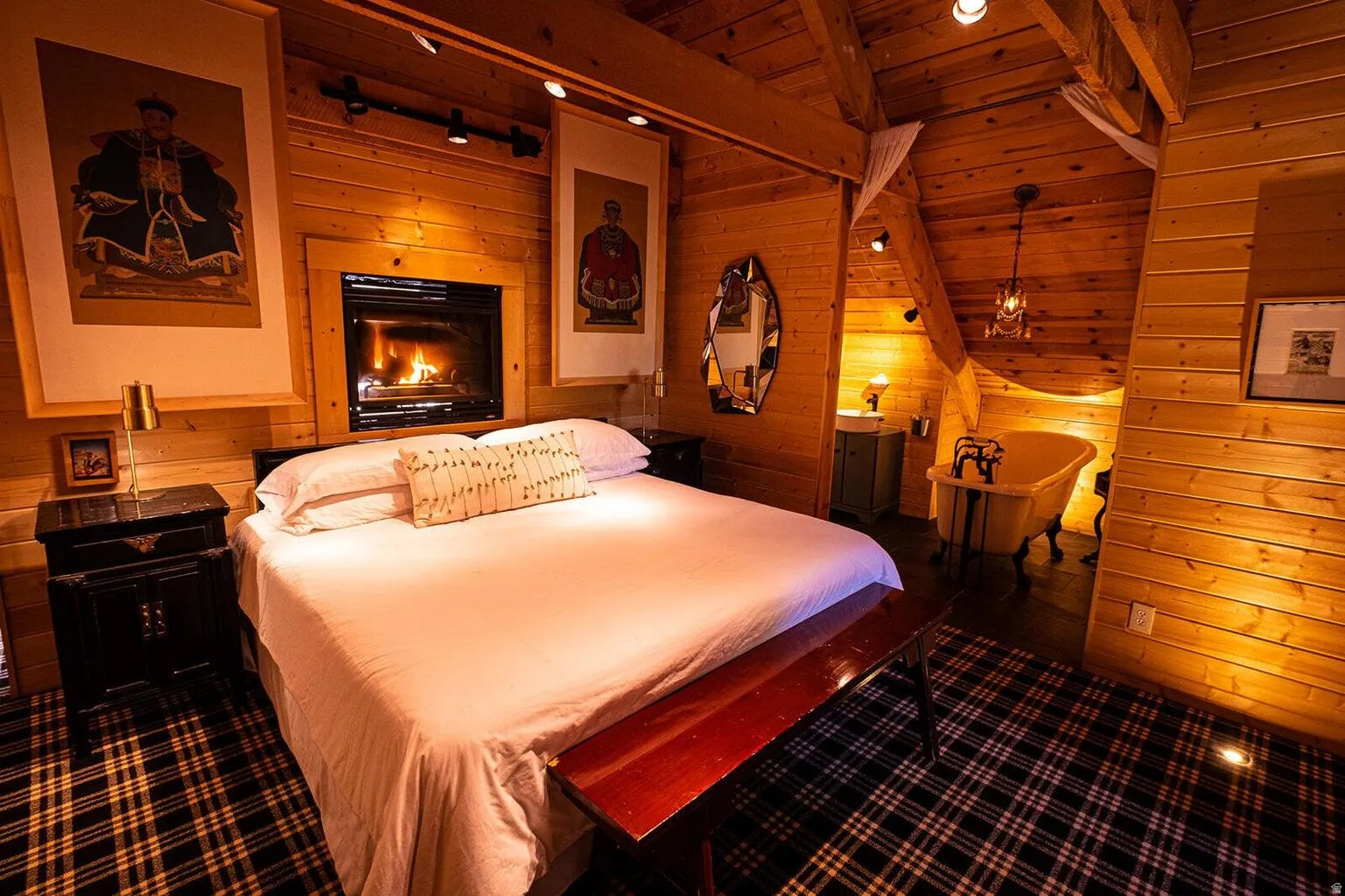 Wood-paneled room featuring a built-in fireplace, sloped ceiling, and plaid-patterned carpet