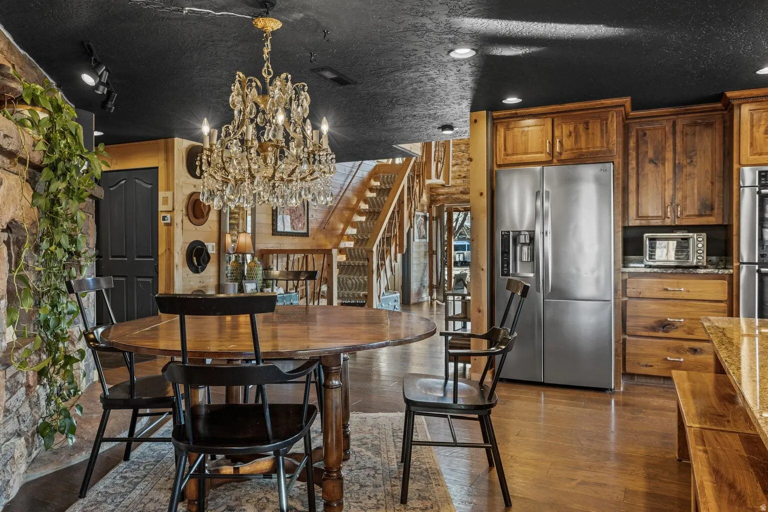 Dining area featuring a prominent chandelier and wood-finish flooring