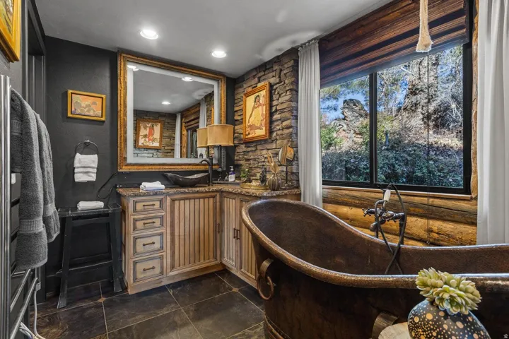 Freestanding copper bathtub with a wall-mounted fixture