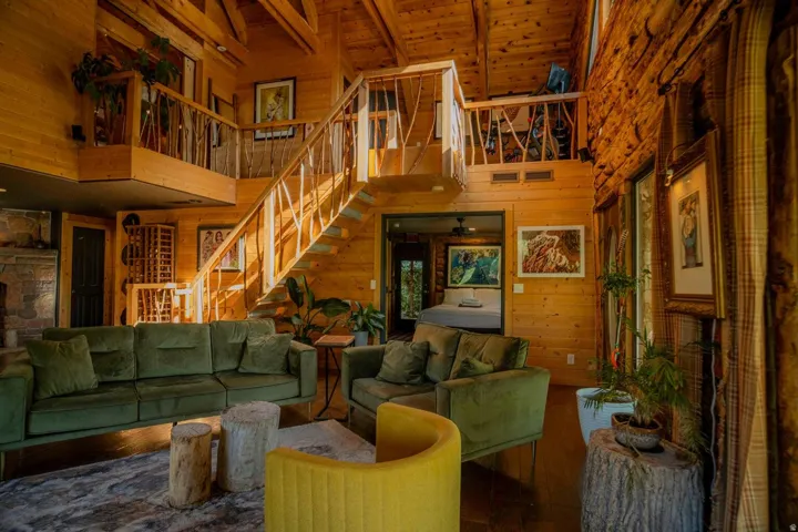 Expansive interior featuring wood-paneled walls and ceiling with exposed beams