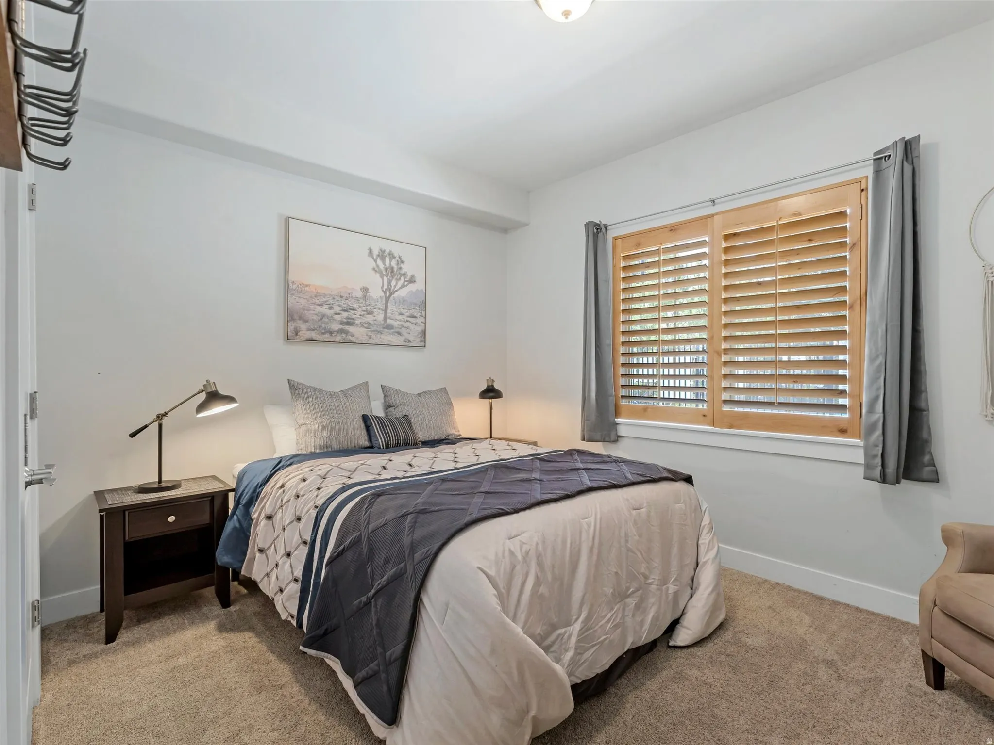 Bedroom featuring light neutral wall paint and plush carpet flooring