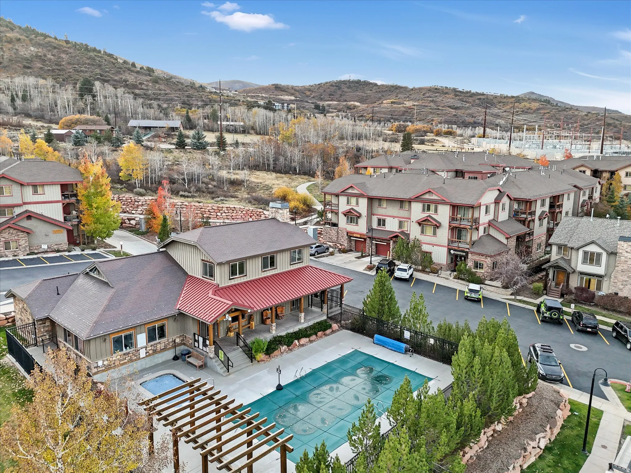 Community amenities featuring a covered swimming pool, hot tub, and pergola