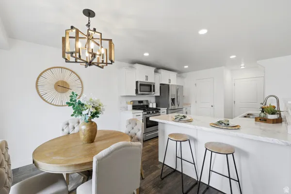 Open-concept kitchen and dining area with wood-finish flooring