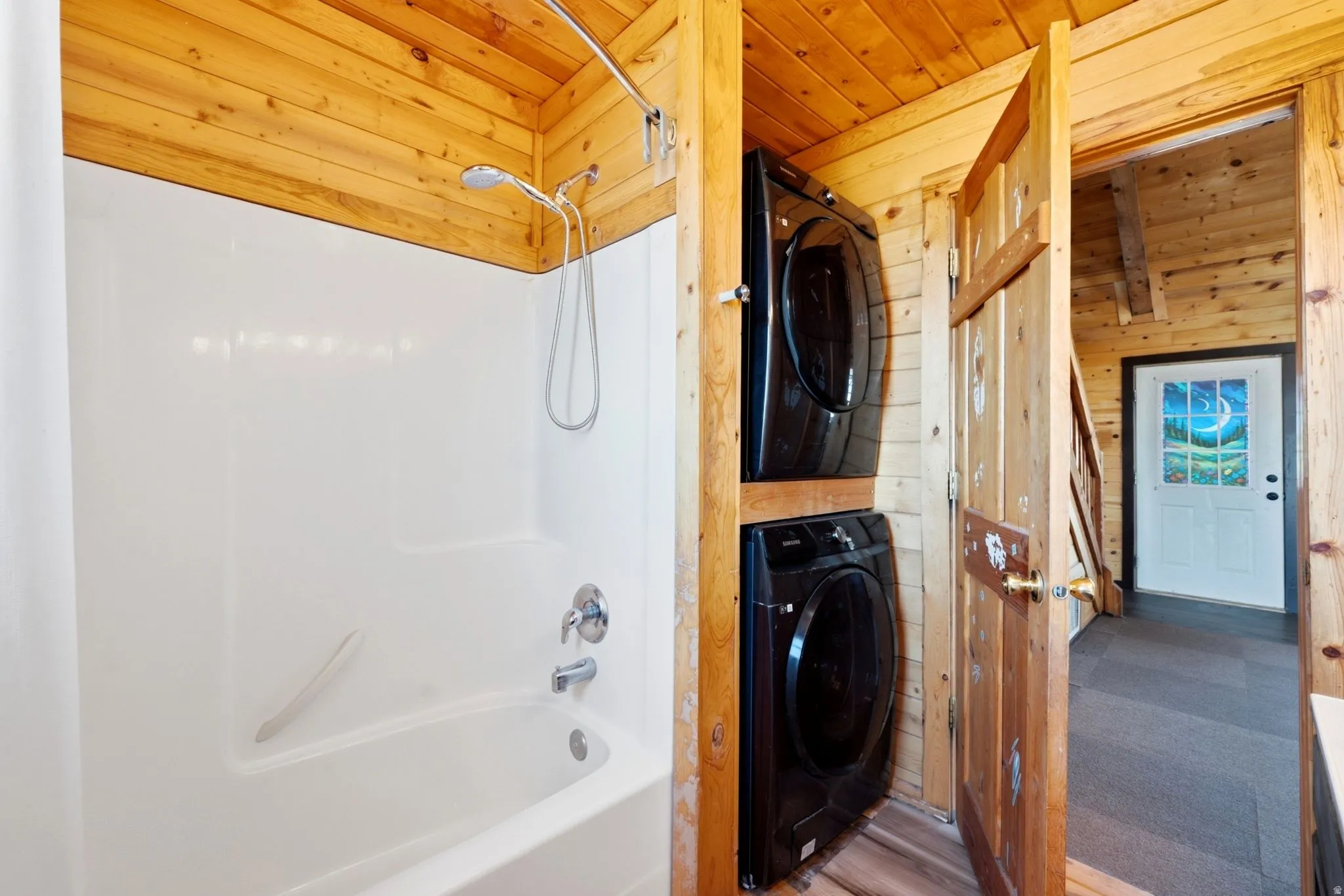 Full bath featuring a white tub-shower combination with chrome fixtures and a handheld showerhead