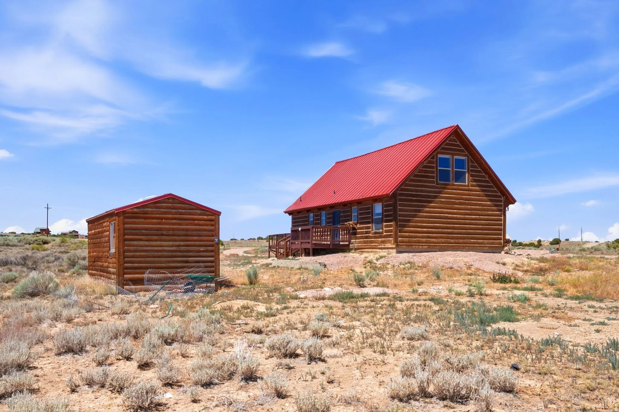 Log cabin-style residence featuring a prominent red metal roof