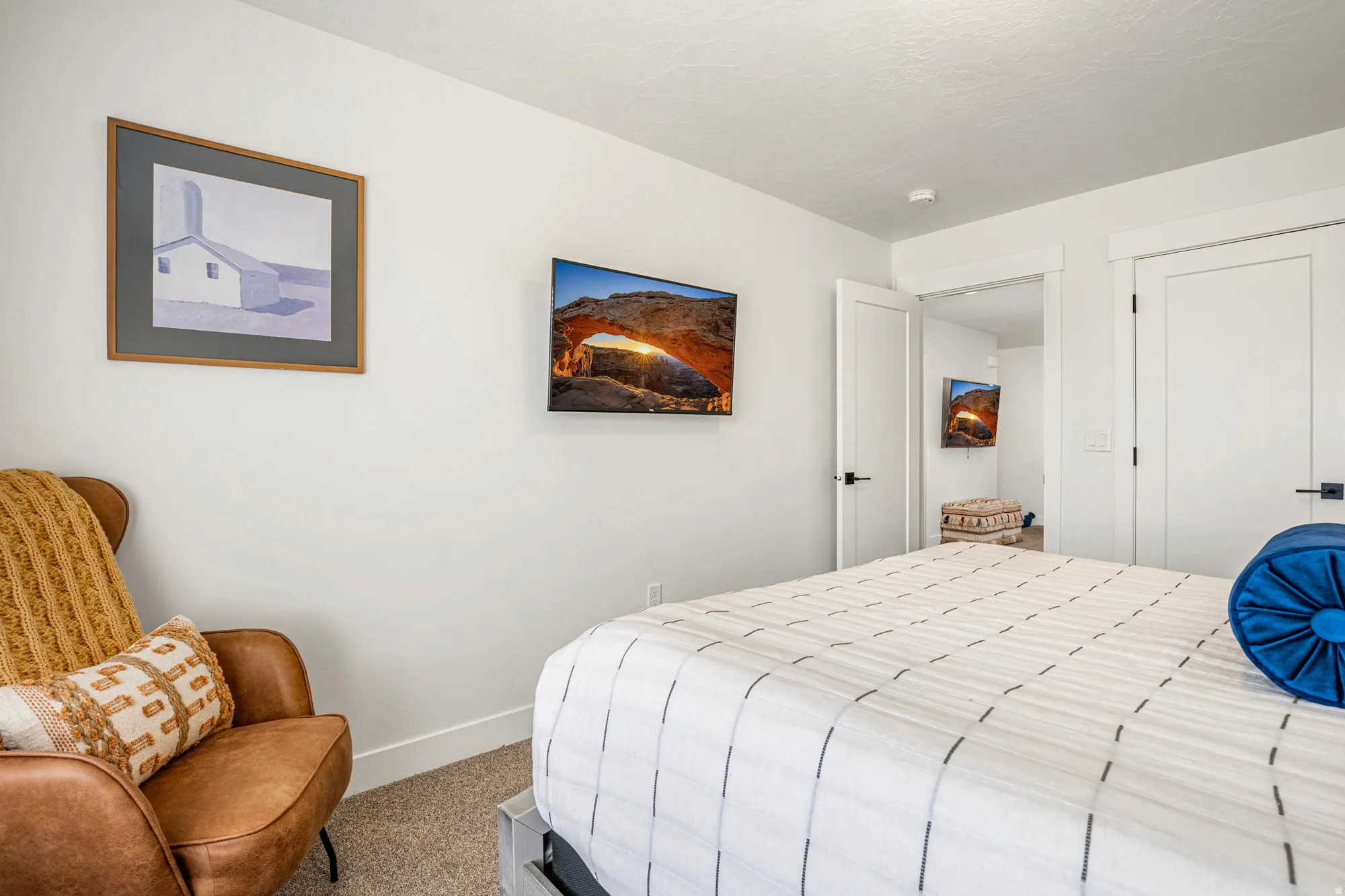 Crisp white walls frame the interior, complemented by clean-lined white doors with matte black hardware