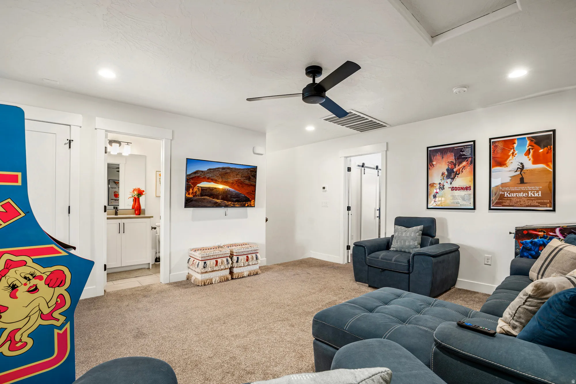 Carpeted recreation room featuring recessed lighting, a ceiling fan, and white walls