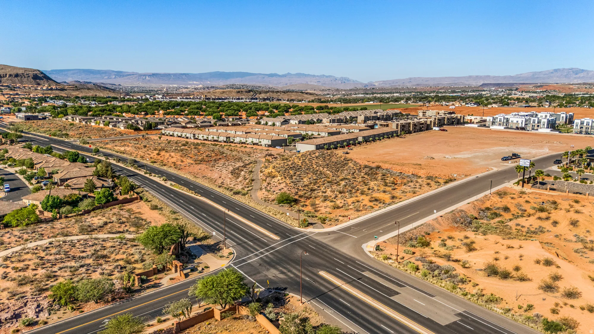 Expansive desert landscape with distant mountains under a clear sky