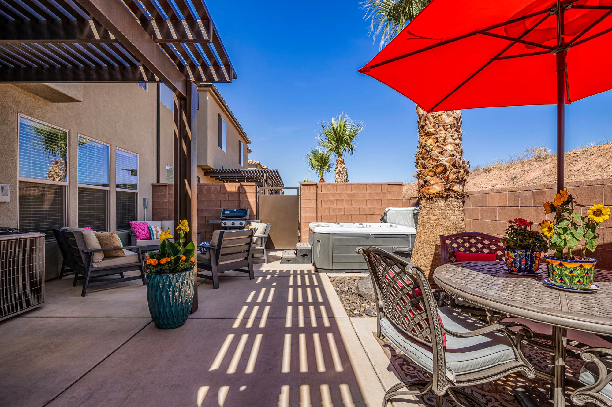 Outdoor patio with concrete flooring and a wood pergola