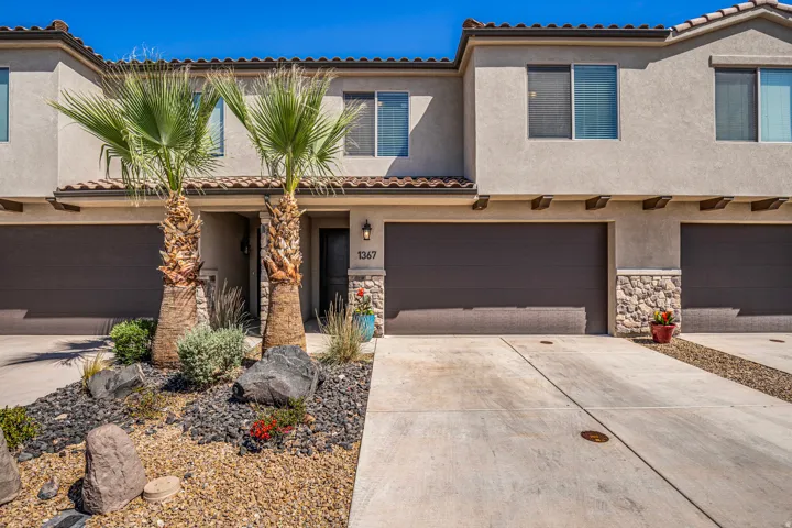 Stucco exterior with stone accents and a terracotta tile roof